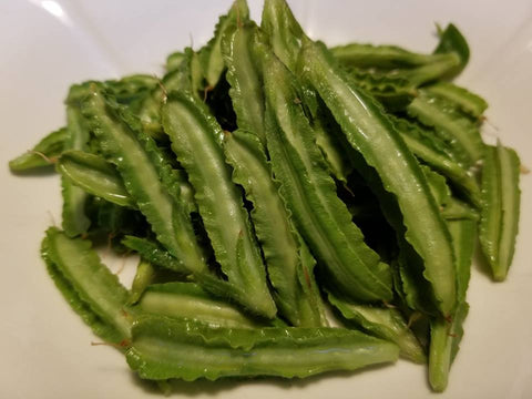Frilly edged 4-lobed asparagus pea pods steamed whole ready for enjoyment